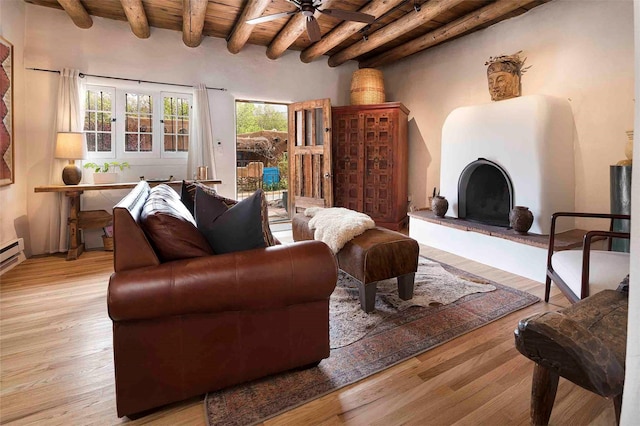 942 Canyon Unit A & B, Santa Fe, NM 87501 - living area with wooden ceiling with exposed beams, a ceiling fan, light wood-type flooring, and a fireplace with raised hearth