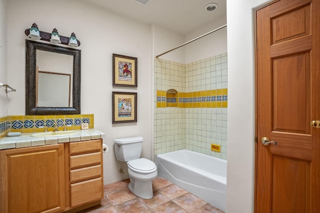 24 Camino Caballos Spur, Lamy, NM 87540 - bathroom with toilet, tile patterned flooring, vanity, tub / shower combination, and backsplash