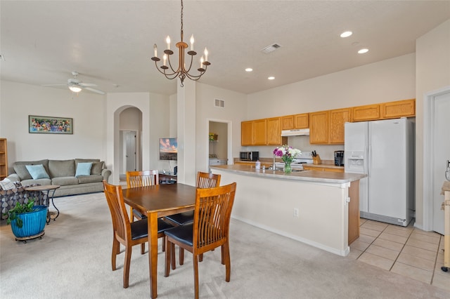 4315 Santo Domingo Unit C, Santa Fe, NM 87507 - dining room with arched walkways, recessed lighting, a ceiling fan, light colored carpet, and light tile patterned flooring