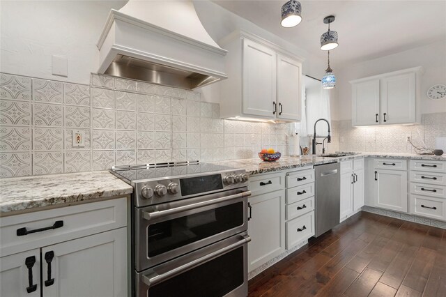 100 Rancho Alegre, Santa Fe, NM 87508 - kitchen with stainless steel appliances, premium range hood, a sink, white cabinetry, and dark wood-type flooring