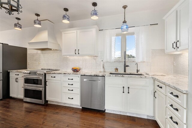 100 Rancho Alegre, Santa Fe, NM 87508 - kitchen with stainless steel appliances, a sink, custom exhaust hood, dark wood-type flooring, and white cabinets