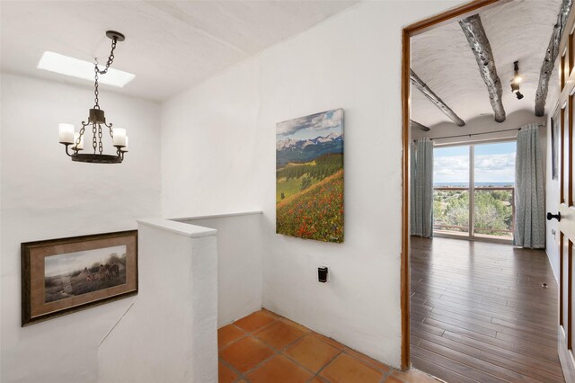 100 Rancho Alegre, Santa Fe, NM 87508 - hallway with a chandelier, a skylight, and an upstairs landing