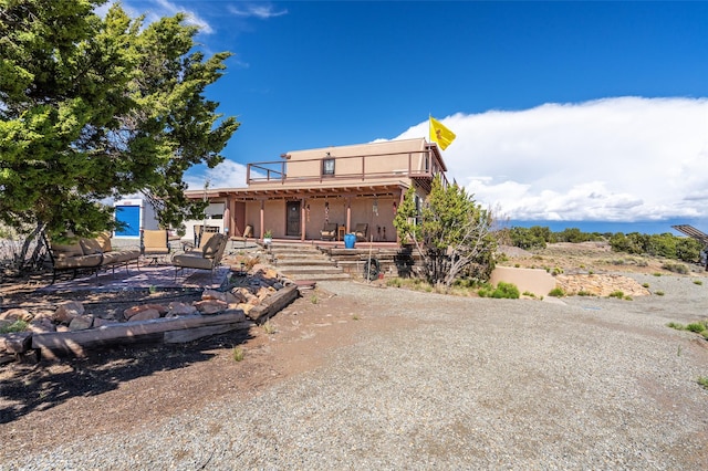 100 Rancho Alegre, Santa Fe, NM 87508 - view of front of house featuring a deck, a patio, and stucco siding
