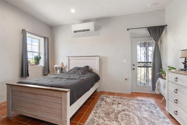 100 Rancho Alegre, Santa Fe, NM 87508 - bedroom featuring an AC wall unit, multiple windows, dark tile patterned floors, recessed lighting, and access to outside