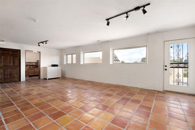 100 Rancho Alegre, Santa Fe, NM 87508 - unfurnished living room with track lighting and light tile patterned flooring