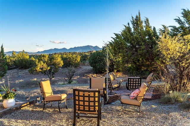 100 Rancho Alegre, Santa Fe, NM 87508 - view of yard featuring a mountain view, a patio area, and an outdoor fire pit