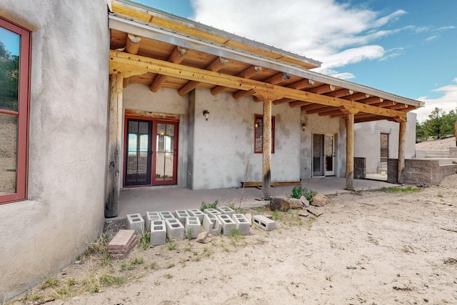 5 Camino Sin Ganas, Santa Fe, NM 87506 - rear view of house featuring stucco siding and a patio