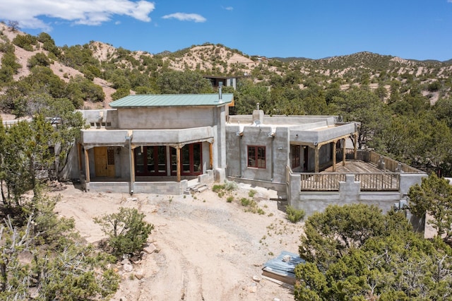 5 Camino Sin Ganas, Santa Fe, NM 87506 - rear view of house featuring a mountain view, a chimney, and a balcony