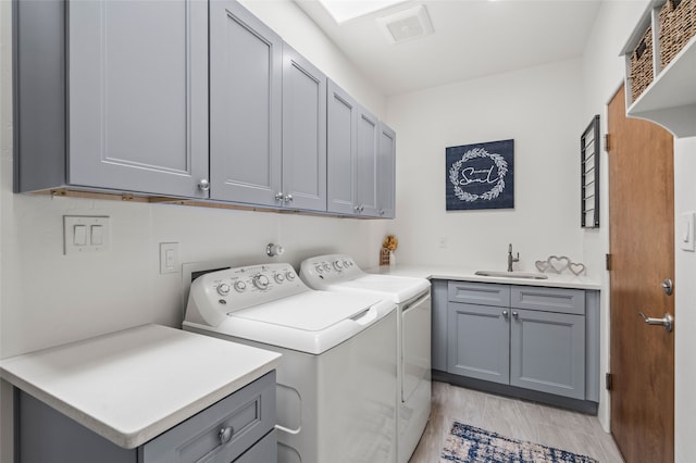 35 La Pradera, Santa Fe, NM 87508 - laundry area with cabinet space, washer and clothes dryer, and light wood-style floors