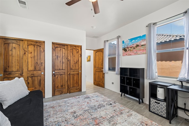 35 La Pradera, Santa Fe, NM 87508 - bedroom featuring two closets and a ceiling fan