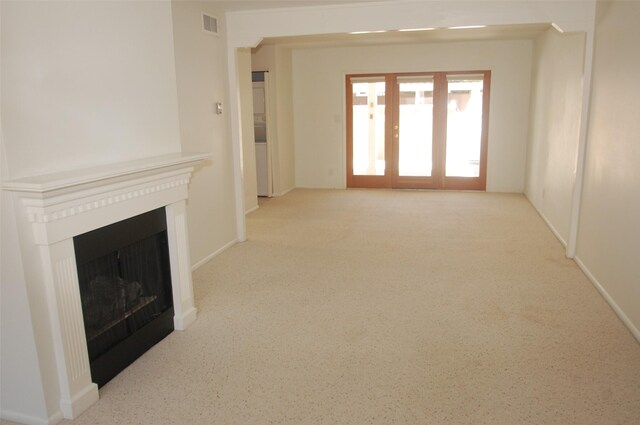 663 Bishops Ldg Unit 64, Santa Fe, NM 87501 - unfurnished living room featuring a fireplace, carpet floors, and baseboards