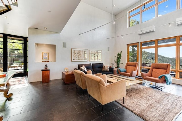 living room with high vaulted ceiling, a wall mounted AC, healthy amount of natural light, and dark tile patterned flooring