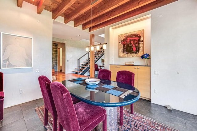 tiled dining room featuring stairway, wood ceiling, and beamed ceiling