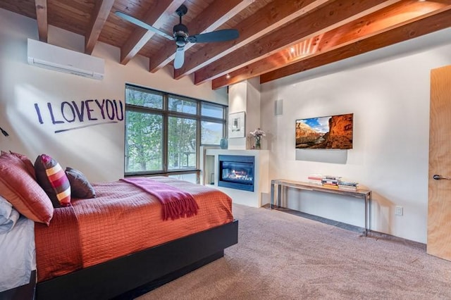bedroom with an AC wall unit, beam ceiling, carpet flooring, wood ceiling, and a glass covered fireplace