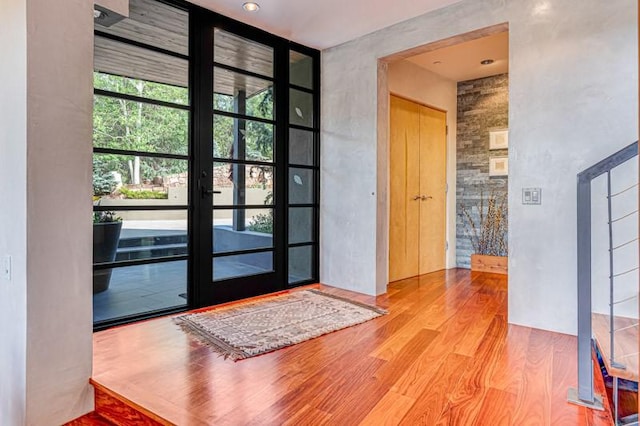 entryway featuring wood finished floors and french doors