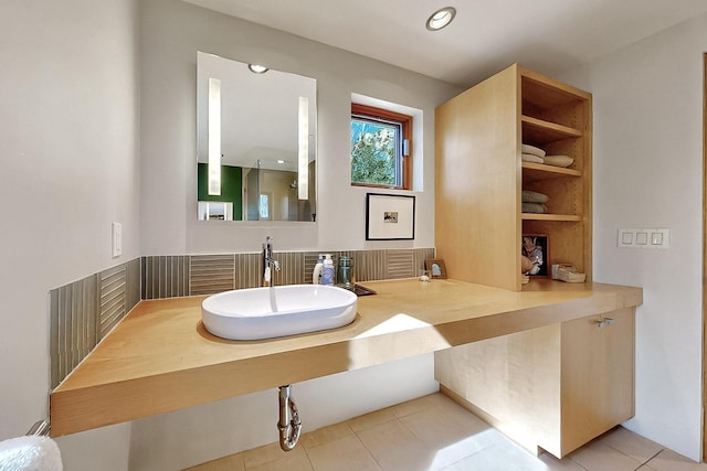 bathroom with a sink, tile patterned flooring, and recessed lighting