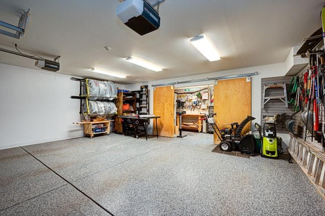garage with a garage door opener and a workshop area