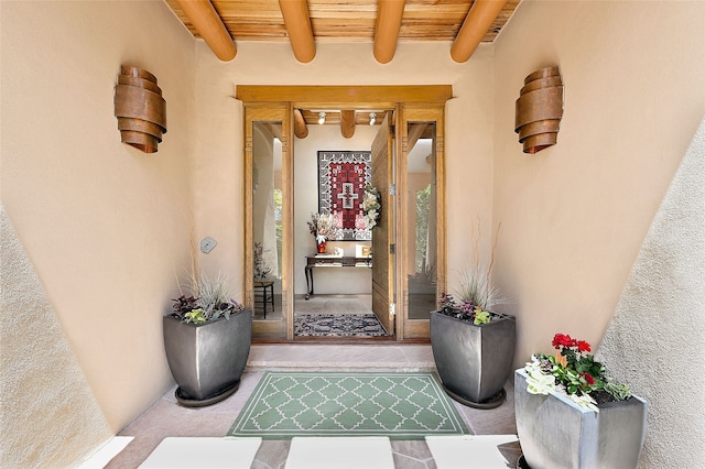 doorway to property featuring stucco siding