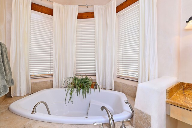 full bath with a garden tub and plenty of natural light