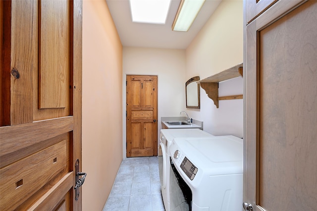 washroom with washing machine and dryer and light tile patterned floors