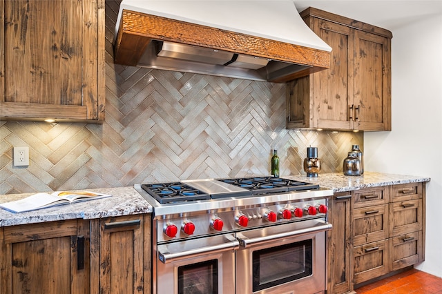 20 San Juan Ranch Rd, Santa Fe, NM 87506 - kitchen featuring range with two ovens, custom exhaust hood, decorative backsplash, and light stone countertops