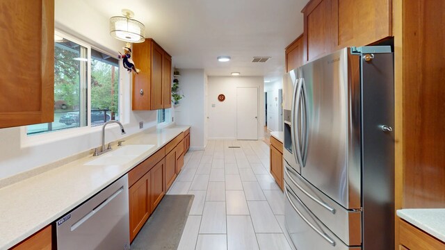 2935 Arizona, Los Alamos, NM 87544 - kitchen with appliances with stainless steel finishes, a sink, brown cabinets, light countertops, and recessed lighting
