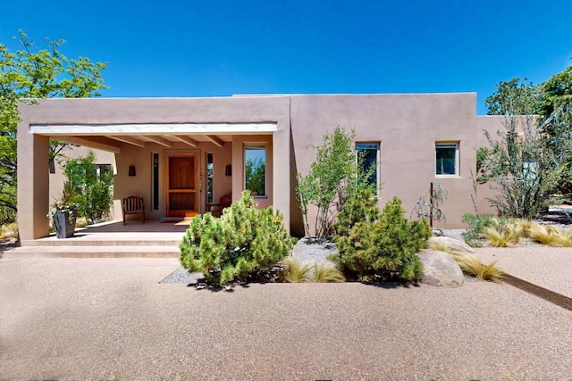 36 Green Meadow Loop, Santa Fe, NM 87506 - pueblo revival-style home featuring stucco siding and a porch