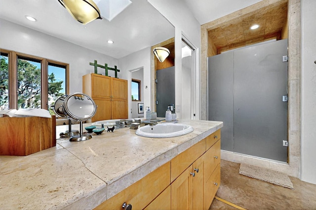 bathroom featuring recessed lighting and vanity