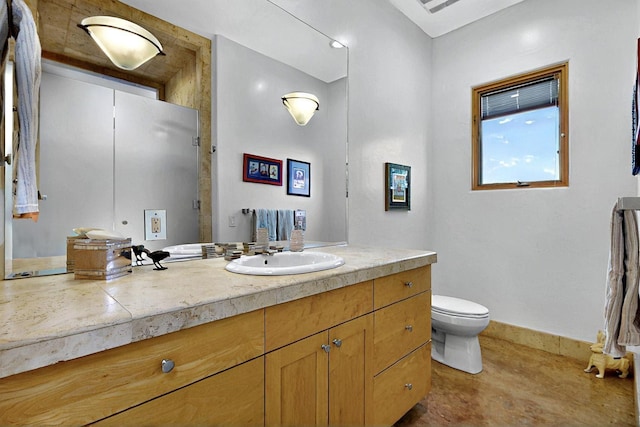 bathroom featuring vanity, toilet, baseboards, and a shower