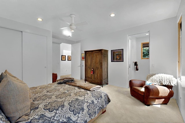 bedroom with light colored carpet, recessed lighting, ceiling fan, and a closet