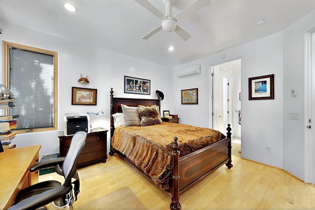 bedroom featuring a wall mounted air conditioner, light wood-type flooring, an office area, recessed lighting, and ceiling fan