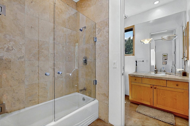 bathroom featuring bath / shower combo with glass door and vanity