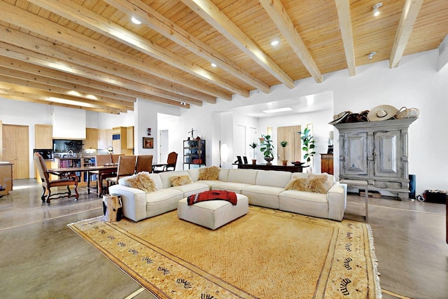 living area with wood ceiling, beam ceiling, and concrete floors