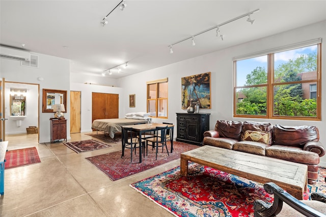 1012 Marquez Pl Unit 310A, Santa Fe, NM 87505 - living room with rail lighting, finished concrete floors, and a wall unit AC