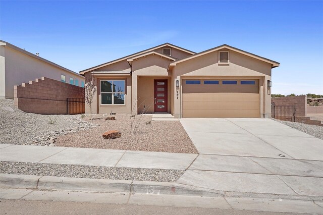 137 Mirador Blvd, Los Alamos, NM 87547 - view of front of home with a garage, fence, stucco siding, and concrete driveway