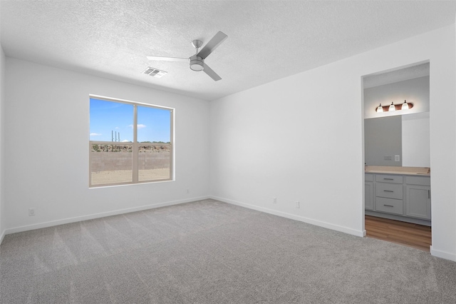 137 Mirador Blvd, Los Alamos, NM 87547 - unfurnished bedroom featuring carpet, ensuite bath, a textured ceiling, baseboards, and a ceiling fan