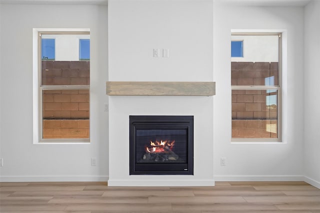137 Mirador Blvd, Los Alamos, NM 87547 - detailed view of wood finished floors, a glass covered fireplace, and baseboards