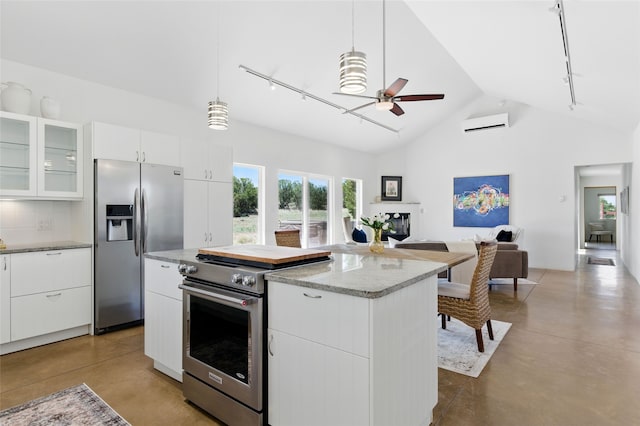 34 Ranch Rd, Lamy, NM 87540 - kitchen featuring rail lighting, stainless steel appliances, ceiling fan, open floor plan, and high vaulted ceiling
