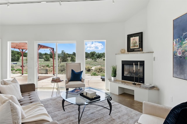 34 Ranch Rd, Lamy, NM 87540 - living area with track lighting, a glass covered fireplace, and finished concrete flooring