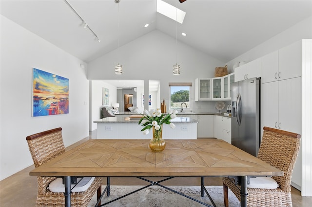34 Ranch Rd, Lamy, NM 87540 - dining room featuring a skylight, high vaulted ceiling, recessed lighting, and track lighting