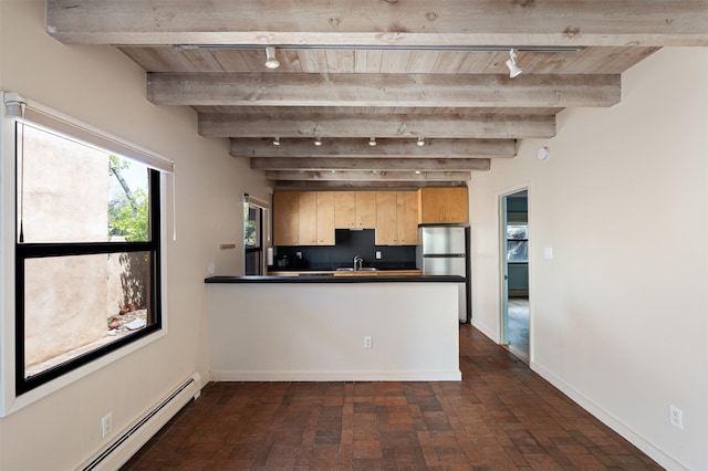 928 Los Lovatos Rd, Santa Fe, NM 87501 - kitchen with track lighting, a baseboard radiator, dark countertops, a peninsula, and wood ceiling