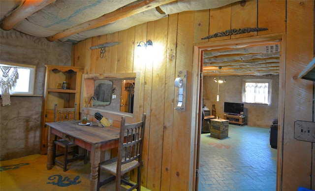 13 Los Amigos, Espanola, NM 87532 - dining room featuring wooden walls, beamed ceiling, and brick floors