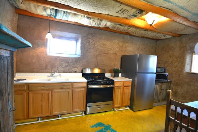 13 Los Amigos, Espanola, NM 87532 - kitchen with stainless steel appliances, light countertops, brown cabinets, and brick floors