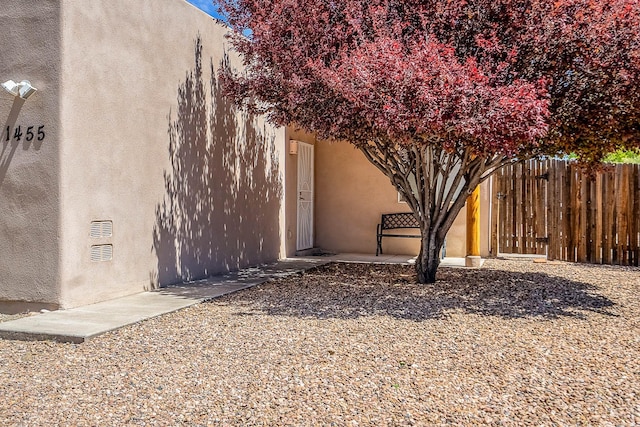 1455 Santiago Loop, Santa Fe, NM 87507 - view of side of home featuring stucco siding and fence