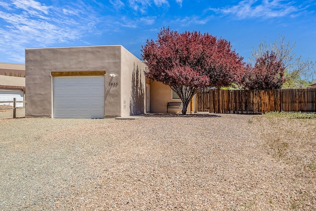 1455 Santiago Loop, Santa Fe, NM 87507 - view of front of house featuring stucco siding and fence