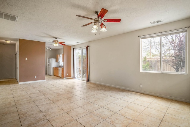 1455 Santiago Loop, Santa Fe, NM 87507 - empty room with ceiling fan, a textured ceiling, baseboards, and light tile patterned floors