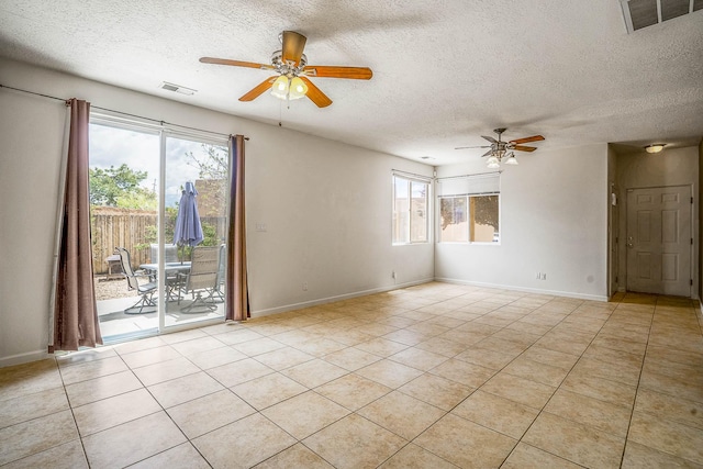 1455 Santiago Loop, Santa Fe, NM 87507 - spare room featuring a ceiling fan, a textured ceiling, light tile patterned flooring, and baseboards