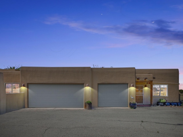 54 Encantado Loop, Santa Fe, NM 87508 - adobe home with stucco siding and an attached garage