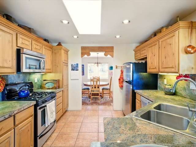 54 Encantado Loop, Santa Fe, NM 87508 - kitchen with stainless steel appliances, a sink, tasteful backsplash, light brown cabinetry, and a skylight
