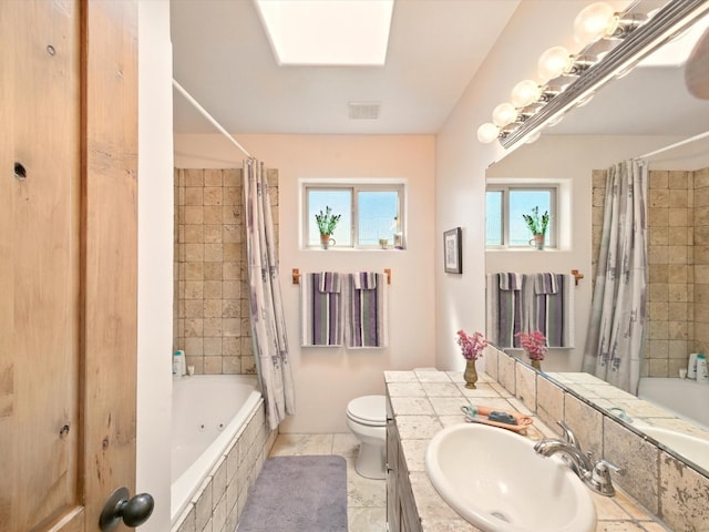 54 Encantado Loop, Santa Fe, NM 87508 - bathroom with healthy amount of natural light, tiled shower / bath, toilet, and vanity
